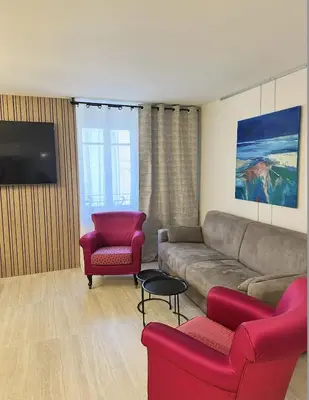 a living room with a couch and two chairs at Elegant old port apartment in Cannes