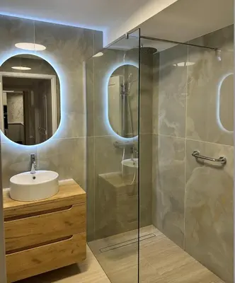 a bathroom with a sink and a shower with a mirror at Elegant old port apartment in Cannes