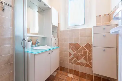 a bathroom with a sink and a mirror at 140m Villa with Pool Near Cannes in Le Cannet