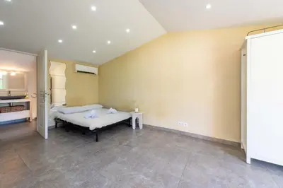 a bedroom with a bed in a room at 140m Villa with Pool Near Cannes in Le Cannet