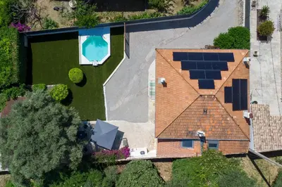 an aerial view of a house with solar panels on the roof at 140m Villa with Pool Near Cannes in Le Cannet