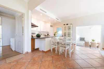 a kitchen and dining room with a table and chairs at 140m Villa with Pool Near Cannes in Le Cannet