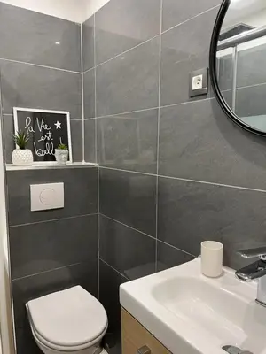 a bathroom with a toilet and a sink and a mirror at Studio à 100 mètres de la plage et de la Croisette in Cannes