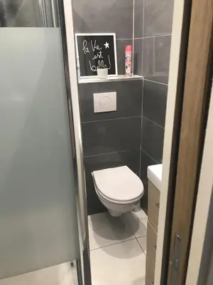 a bathroom with a toilet and a black wall at Studio à 100 mètres de la plage et de la Croisette in Cannes