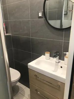 a bathroom with a sink and a mirror and a toilet at Studio à 100 mètres de la plage et de la Croisette in Cannes