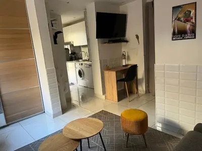 a kitchen with a table and two chairs and a tv at Studio à 100 mètres de la plage et de la Croisette in Cannes