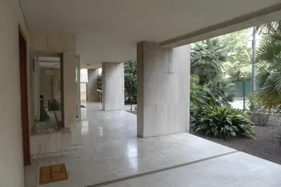 a hallway of a building with columns and plants at Studio à 100 mètres de la plage et de la Croisette in Cannes