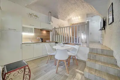 a kitchen with a table and chairs in a room at Sandra - Atypical and Charming - Suquet - VCA in Cannes
