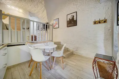 a dining room with a white table and chairs at Sandra - Atypical and Charming - Suquet - VCA in Cannes