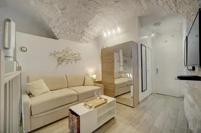 a living room with a couch and a table at Sandra - Atypical and Charming - Suquet - VCA in Cannes