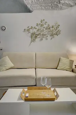 a couch with two wine glasses on a table at Sandra - Atypical and Charming - Suquet - VCA in Cannes