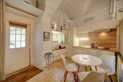 a kitchen with a white table and chairs and a table at Sandra - Atypical and Charming - Suquet - VCA in Cannes