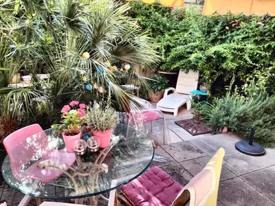 a glass table with plants on a patio at Near Croisette atypic studio garden pool in Cannes