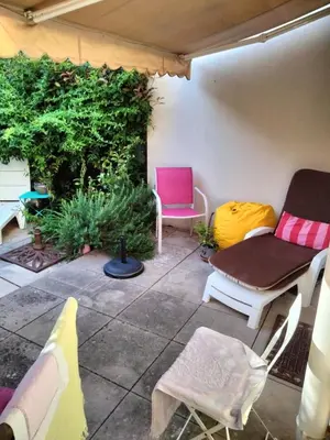 a patio with two chairs and a table at Near Croisette atypic studio garden pool in Cannes