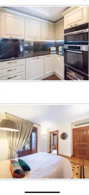 a kitchen with white cabinets and a bed in it at Luxury apartment in Cannes in Cannes