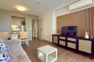 a living room with a couch and a flat screen tv at Vue Mer Azur - Villa France Cannes in Cannes