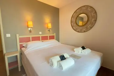 a bedroom with a bed with two towels on it at Vue Mer Azur - Villa France Cannes in Cannes