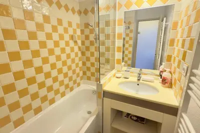 a bathroom with a sink and a bath tub and a sink at Vue Mer Azur - Villa France Cannes in Cannes
