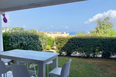 a white table and chairs on a patio at Vue Mer Azur - Villa France Cannes in Cannes