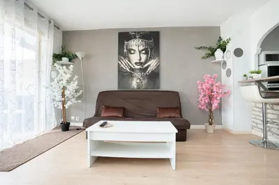 a living room with a couch and a table at Charmant 2 Pièces au Cannet in Le Cannet