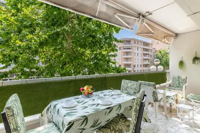 a table and chairs on a balcony with a view at Magnifique appartement proche plages et palais in Cannes
