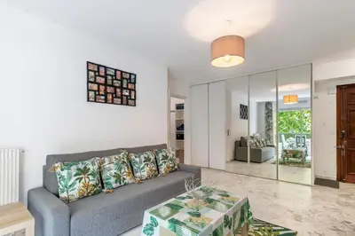a living room with a couch and a table at Magnifique appartement proche plages et palais in Cannes