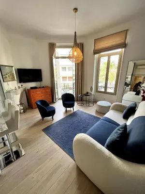 a living room with a couch and a blue rug at T2 coeur de Cannes a 2 pas de la croisette in Cannes