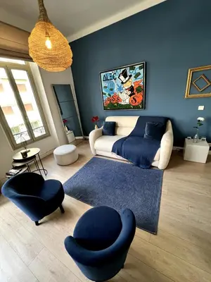 a bedroom with a bed and a blue wall at T2 coeur de Cannes a 2 pas de la croisette in Cannes