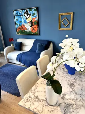 a blue living room with a table and a couch at T2 coeur de Cannes a 2 pas de la croisette in Cannes