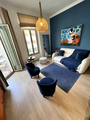 a living room with a bed and blue walls at T2 coeur de Cannes a 2 pas de la croisette in Cannes
