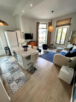 a living room with a couch and a table at T2 coeur de Cannes a 2 pas de la croisette in Cannes