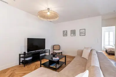 a living room with a couch and a flat screen tv at Apartment 2 bedrooms near beach - Cannes in Cannes