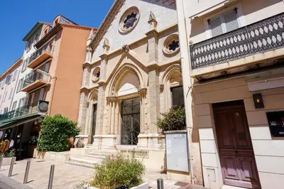a building with a clock on the side of it at Notre Dame - Terrace, AC, 3mn from Palais & Beach, modern in Cannes