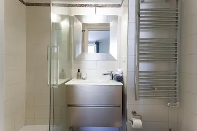 a bathroom with a sink and a mirror at Notre Dame - Terrace, AC, 3mn from Palais & Beach, modern in Cannes