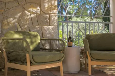 two chairs and a bottle of wine on a patio at Villa Lou San Peyre, Cannes et Mougins, 4 km des plages in Le Cannet