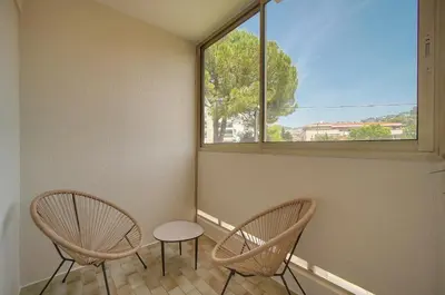 a living room with a tv and white shelves at Char - Piscine - Parking - VCA in Le Cannet