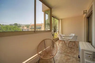 a living room with a couch and a tv at Char - Piscine - Parking - VCA in Le Cannet