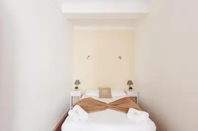 a bedroom with a bed with a bow on it at Immogroom - T2 - 10 min walk from Palais in Cannes