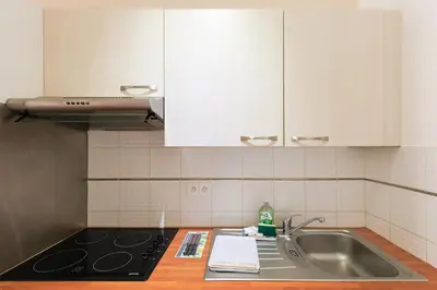 a kitchen with a sink and a counter top at Immogroom - T2 - 10 min walk from Palais in Cannes