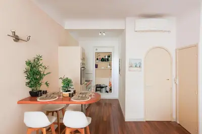 a kitchen and dining room with a table and stools at Immogroom - T2 - 10 min walk from Palais in Cannes