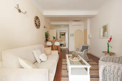a living room with a white couch and a table at Immogroom - T2 - 10 min walk from Palais in Cannes