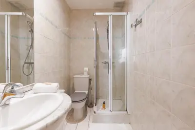 a bathroom with a shower and a toilet and a sink at Immogroom - T2 - 10 min walk from Palais in Cannes