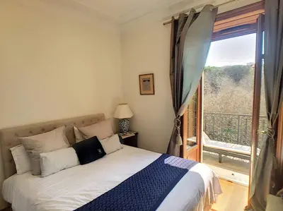 a bedroom with a bed and a large window at FRGK OXFORD palace park in Cannes