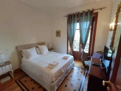a bedroom with a white bed and a television at FRGK OXFORD palace park in Cannes