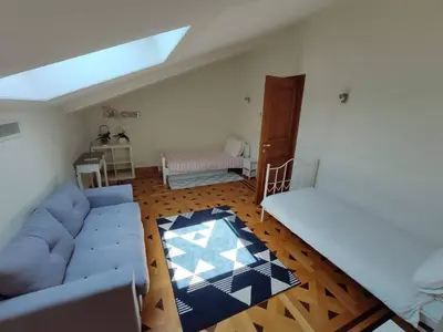 a living room with a blue couch and wooden floors at FRGK OXFORD palace park in Cannes