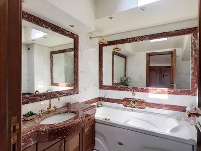 a bathroom with a tub and a sink and two mirrors at FRGK OXFORD palace park in Cannes
