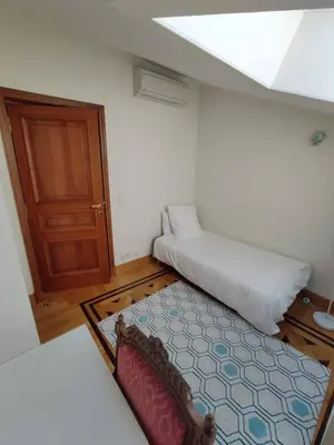 a small room with a bed and a door at FRGK OXFORD palace park in Cannes