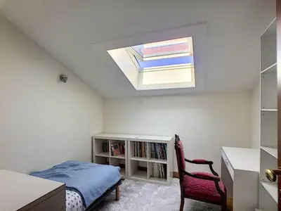 a bedroom with a bed and a desk and a skylight at FRGK OXFORD palace park in Cannes