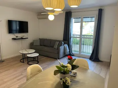 a living room with a couch and a table at 4 People Cannes Hyper Centre and Air conditioning in Cannes