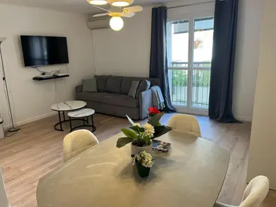 a living room with a table and a couch at 4 People Cannes Hyper Centre and Air conditioning in Cannes